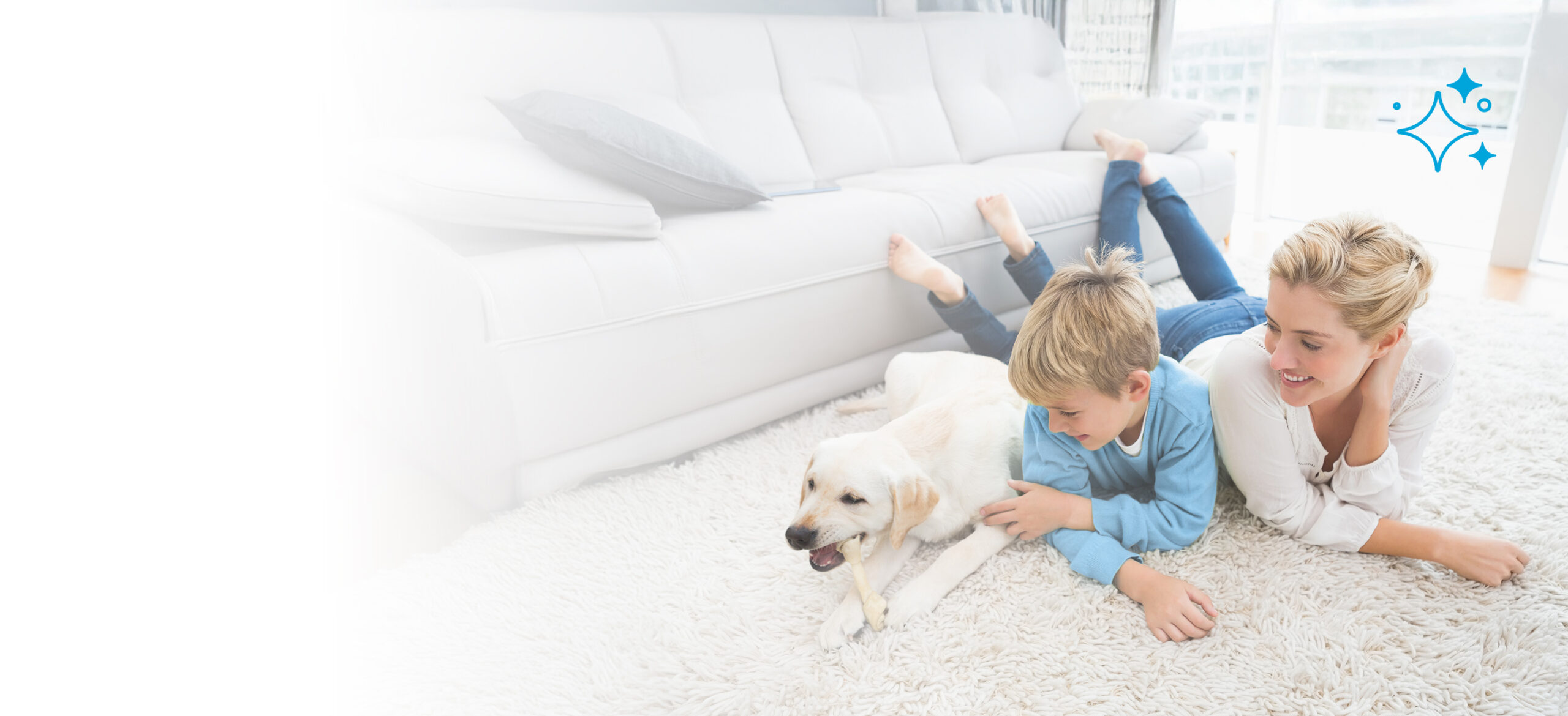 Mother and son smiling with their dog on a clean white carpet in a bright living room