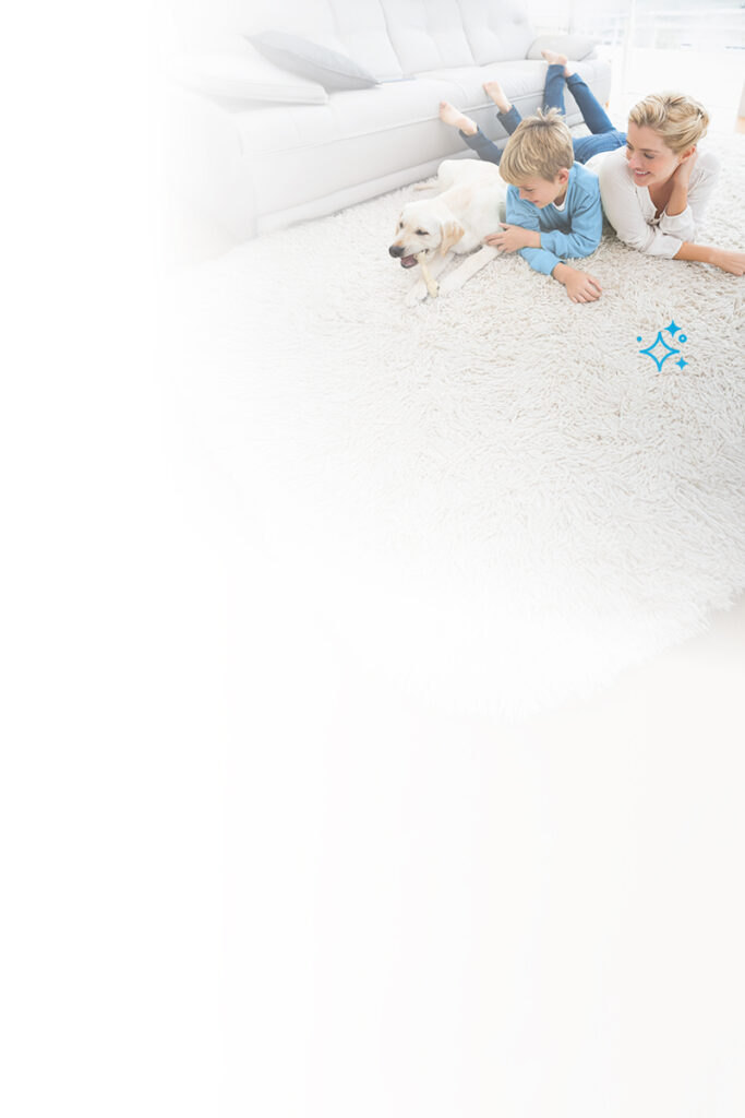 Mother and son smiling with their dog on a clean white carpet in a bright living room